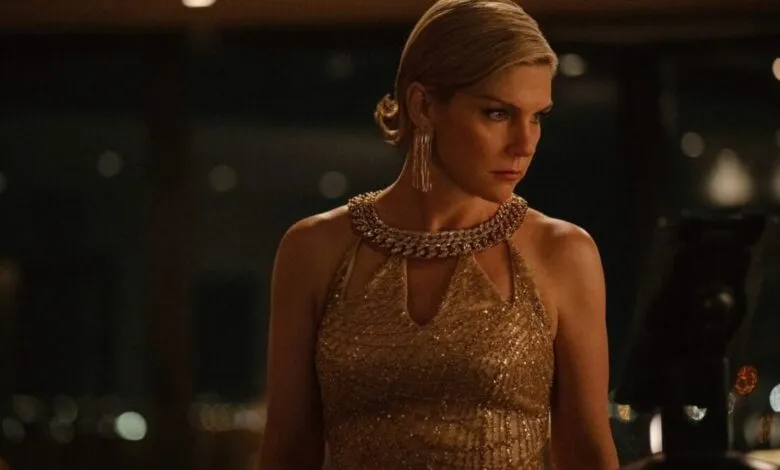 Rhea Seehorn in a gold dress with a serious expression.