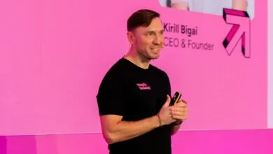 Kirill Bigai, CEO of Preply, presenting on a pink stage.