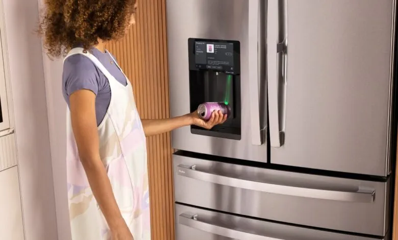 Woman uses smart fridge to scan a drink can with a green laser.