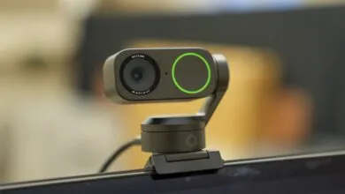 Insta360 webcam mounted on a laptop screen.