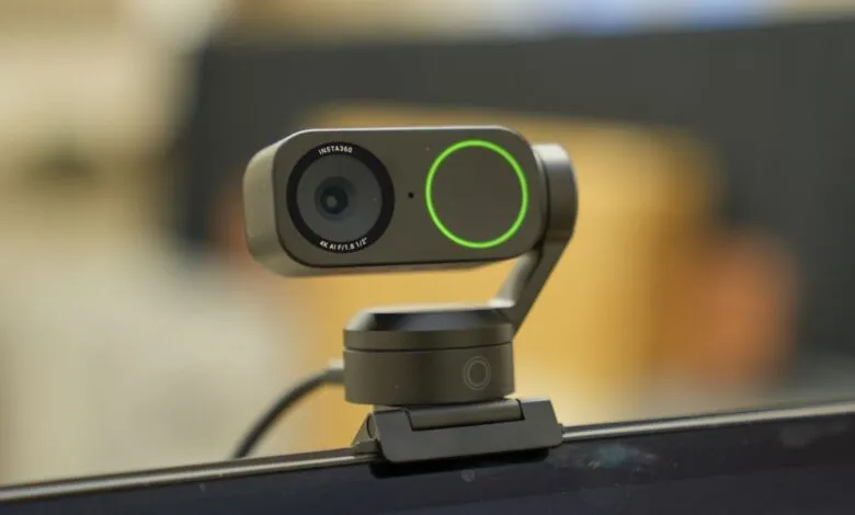 Insta360 webcam mounted on a laptop screen.