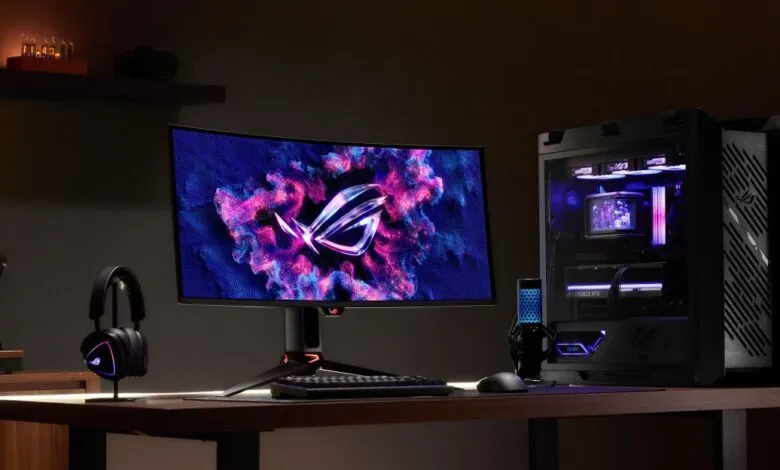 ROG gaming setup featuring curved monitor, PC, keyboard, mouse, and headset.
