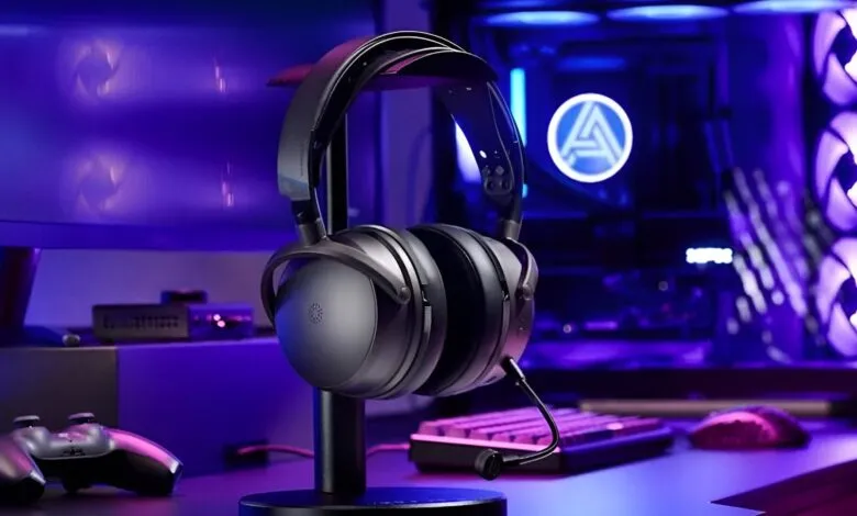 Gaming headset on stand with keyboard, controller, and PC in background.