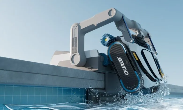 Robotic pool cleaner entering pool with splash, gray and blue design.