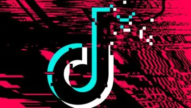 Distorted TikTok logo with glitching effect in pink, black, and cyan.