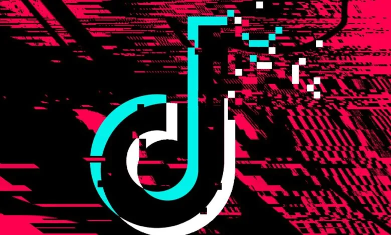 Distorted TikTok logo with glitching effect in pink, black, and cyan.