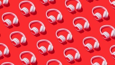 Pattern of white headphones arranged on a bright red background.