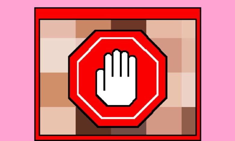 Pixelated stop sign with hand on skin tone background.
