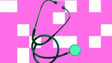 Stethoscope on pink and white checkered background.