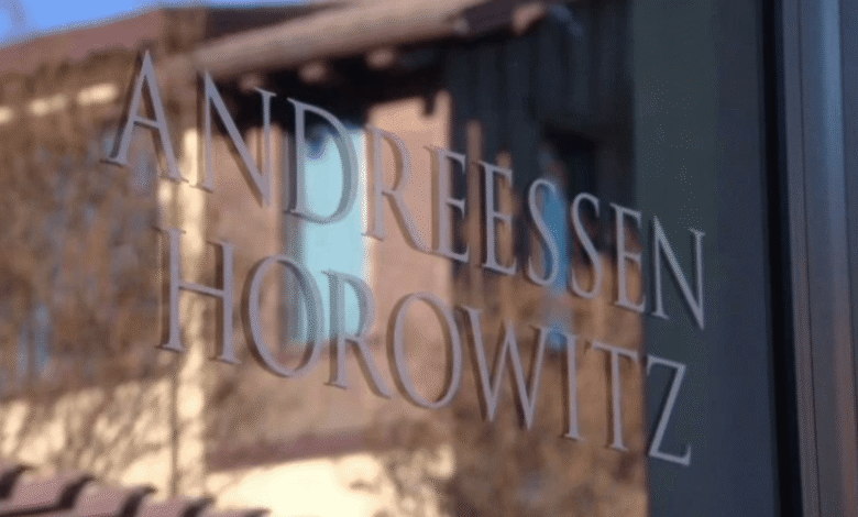 Andreesen Horowitz logo on glass door, building reflected.