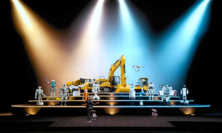 Robots and construction vehicles on a lit stage, person in foreground.