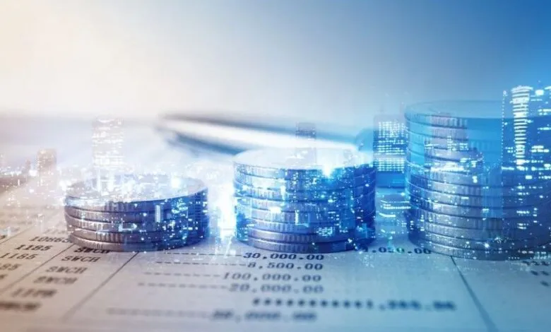 Stacks of coins on bank statement, overlaid with city skyline.