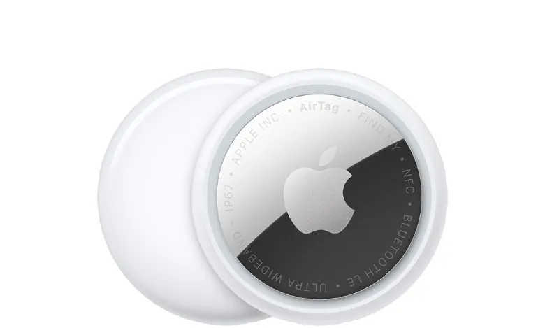 Two Apple AirTags, one with the back removed, on a white background.