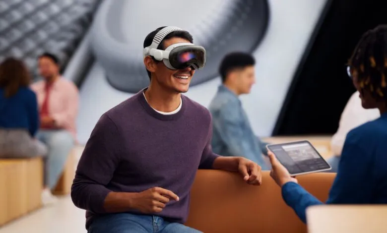 Man smiles while wearing Apple Vision Pro headset during a demo.