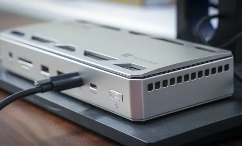 Silver Thunderbolt dock with black cable plugged into the front.