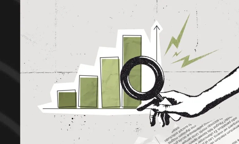 Rising bar graph analyzed with magnifying glass, growth concept.