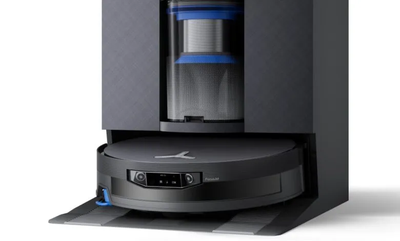 Robot vacuum cleaner docked in its charging and dust-emptying station.