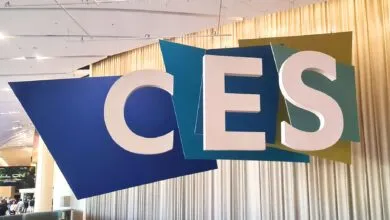 Large CES sign with blue and green geometric shapes.