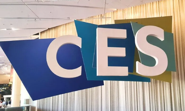 Large CES sign with blue and green geometric shapes.