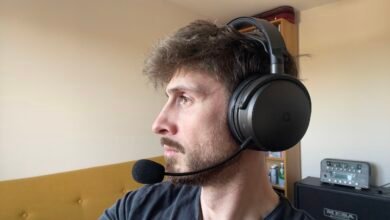 Man wearing black gaming headset with microphone, looking left.