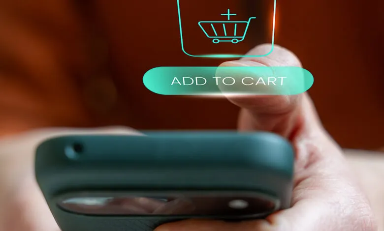 Person adds item to cart on phone, online shopping concept.