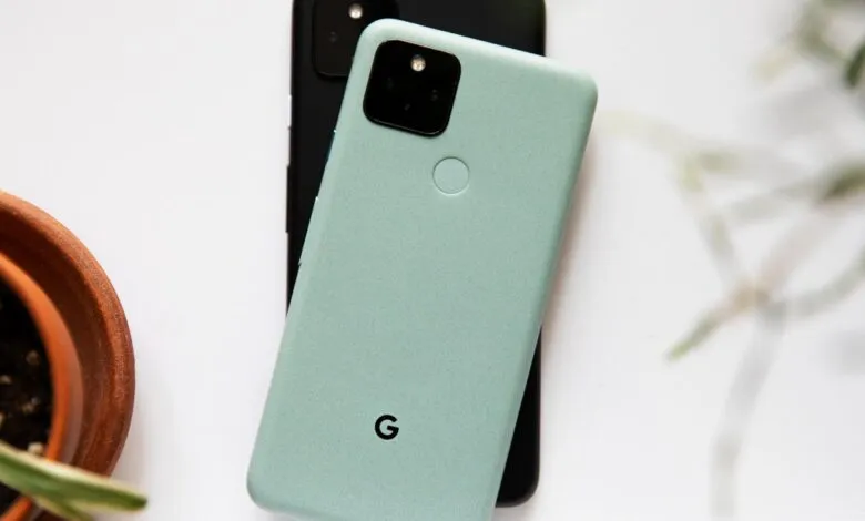 Two Google Pixel phones, one mint green, one black, on a white surface.