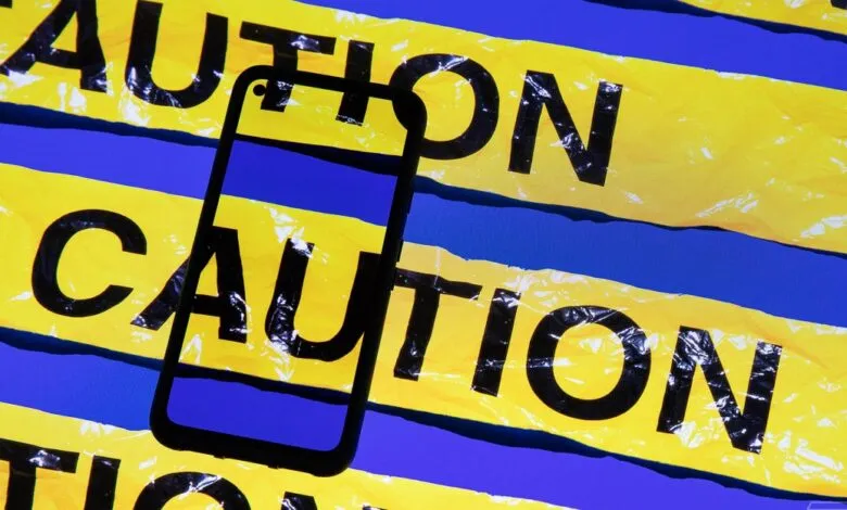 Smartphone outline on caution tape background, blue and yellow.