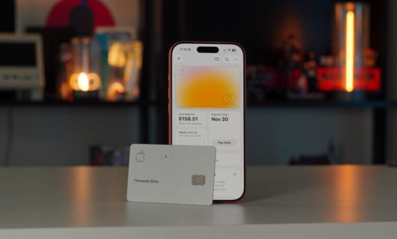 Apple Card and iPhone displaying card details on a light surface.