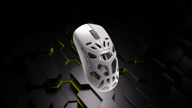 White gaming mouse with honeycomb design floating above a geometric background.