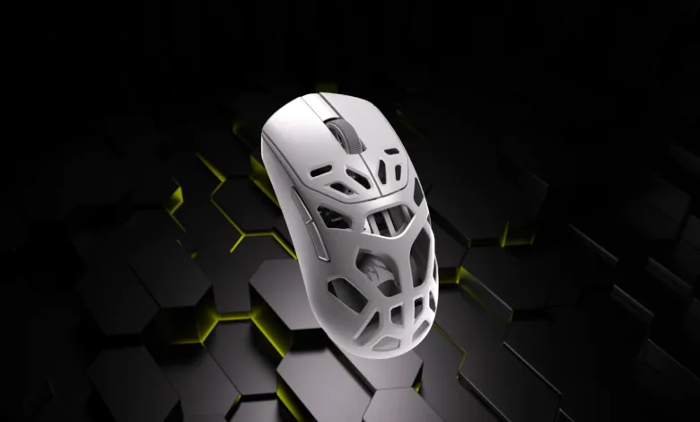 White gaming mouse with honeycomb design floating above a geometric background.