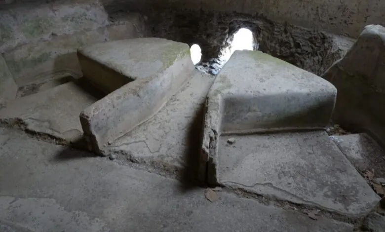 Ancient stone structure with openings for light in a weathered interior.