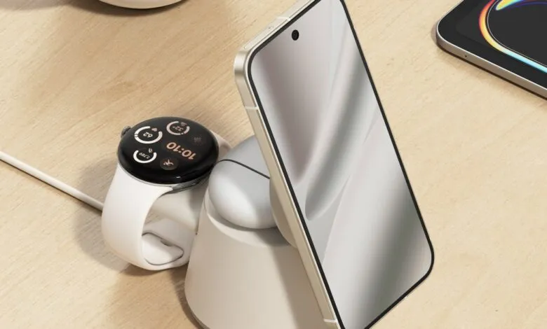 Charging station with phone, earbuds, and smartwatch on a wood surface.