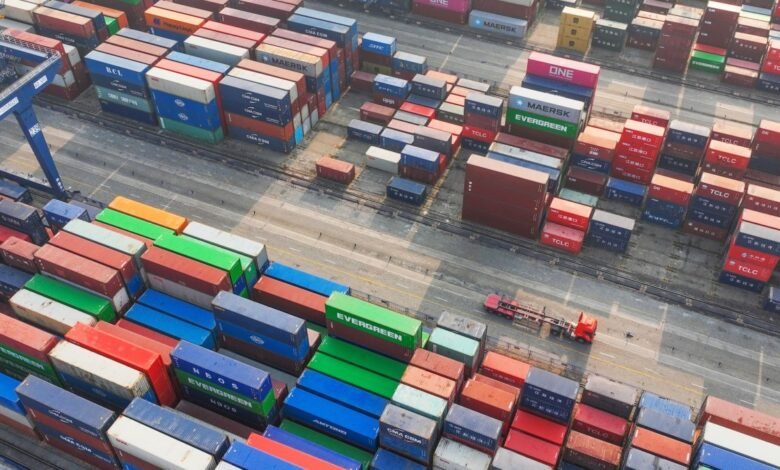 Aerial view of a shipping yard filled with colorful stacked containers.