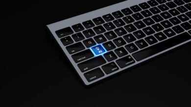 Keyboard with a glowing 'AI' key, symbolizing artificial intelligence.