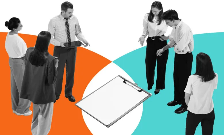 Group of professionals collaborating around a clipboard.