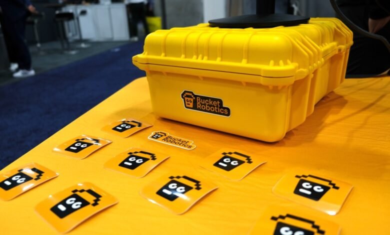 Yellow Bucket Robotics box with stickers on a matching table.