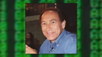 Portrait of Hal Finney smiling in a blue shirt.