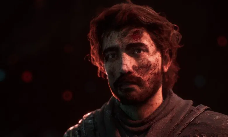 Close-up of a man with blood and dirt on his face, looking determined.