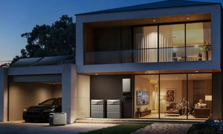 Modern home with solar panels, battery storage, and family inside.