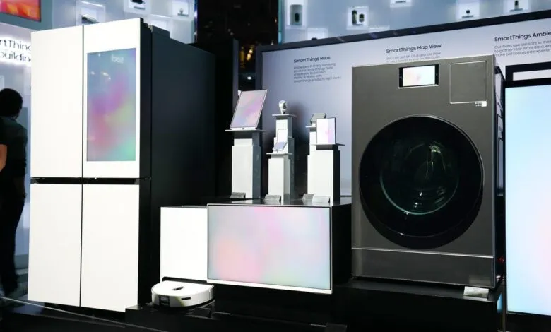 Samsung SmartThings devices on display: refrigerator, washer, tablets, and robot vacuum.