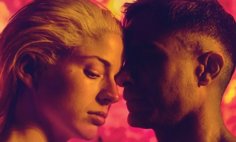 Close-up of a woman and man facing each other, foreheads nearly touching.