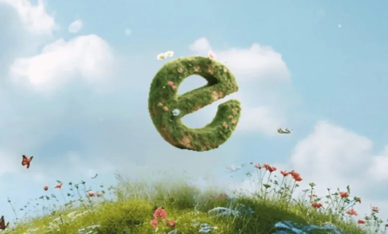 Green letter 'e' floating above a grassy hill with flowers and butterflies.