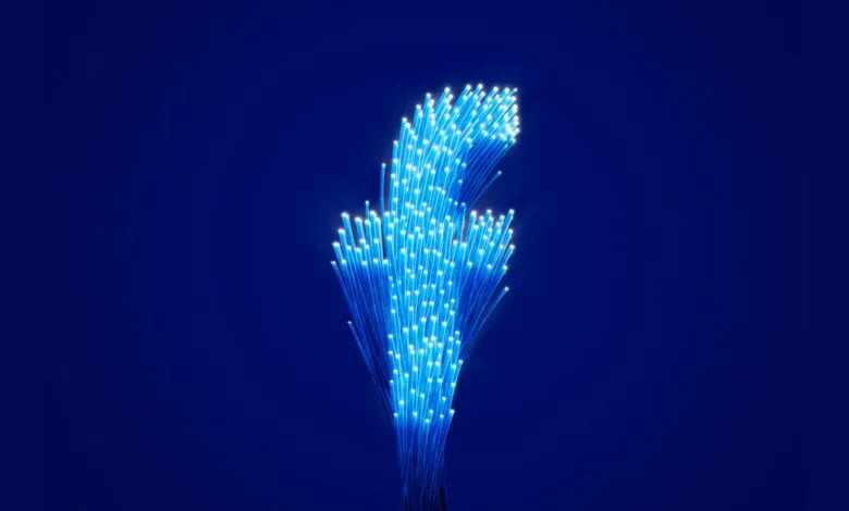 Fiber optic cables glowing blue against a dark blue background.