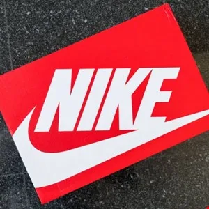 Close-up of a red Nike shoebox with a white swoosh logo.