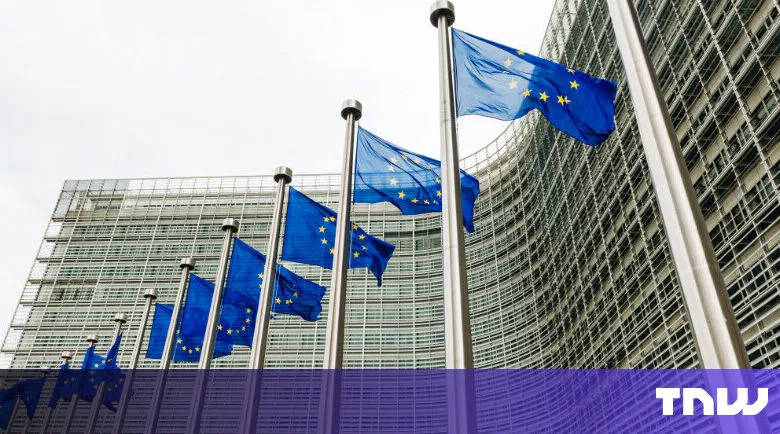 Row of EU flags waving in front of modern building.