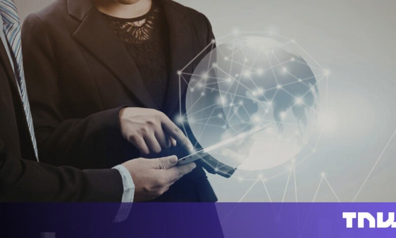 Two business professionals analyze data on a tablet with global network overlay.