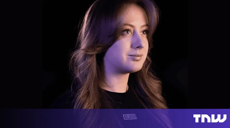 Portrait of a woman with long brown hair against a dark background.