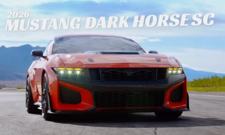 Red 2026 Ford Mustang Dark Horse SC with black accents on a racetrack.