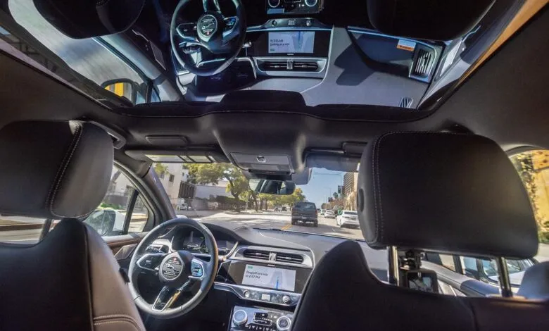 Interior view of car with sunroof, showing dashboard and road ahead.