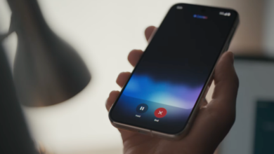 Hand holding smartphone with call interface showing hold and end buttons.